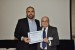 Dr. Nagib Callaos, General Chair, giving Sr. Roberto-Carlos Valdés Hernández the best paper award certificate of the session "Informática / Cibernética y sus Aplicaciones en Ciencia e Ingeniería." The title of the awarded paper is "Análisis del Desarrollo del Software en Pequeñas y Medianas Empresas (PYMES) del Estado de Baja California, México."